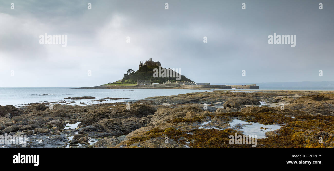 View across rocky foreshore towards St Michaels Mount, Marazion in South Cornwall Stock Photo