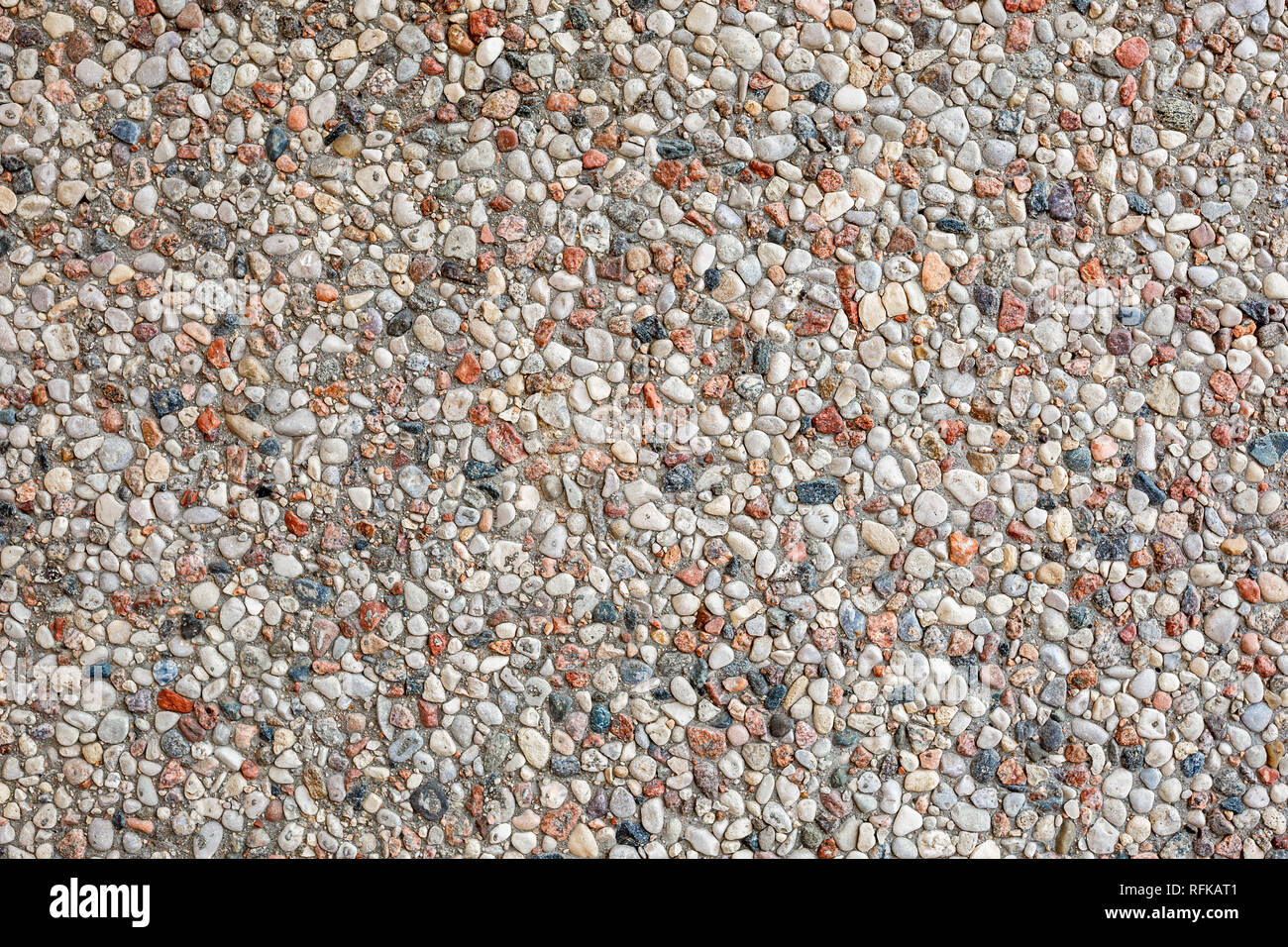 wall of small stones pebbles texture background Stock Photo