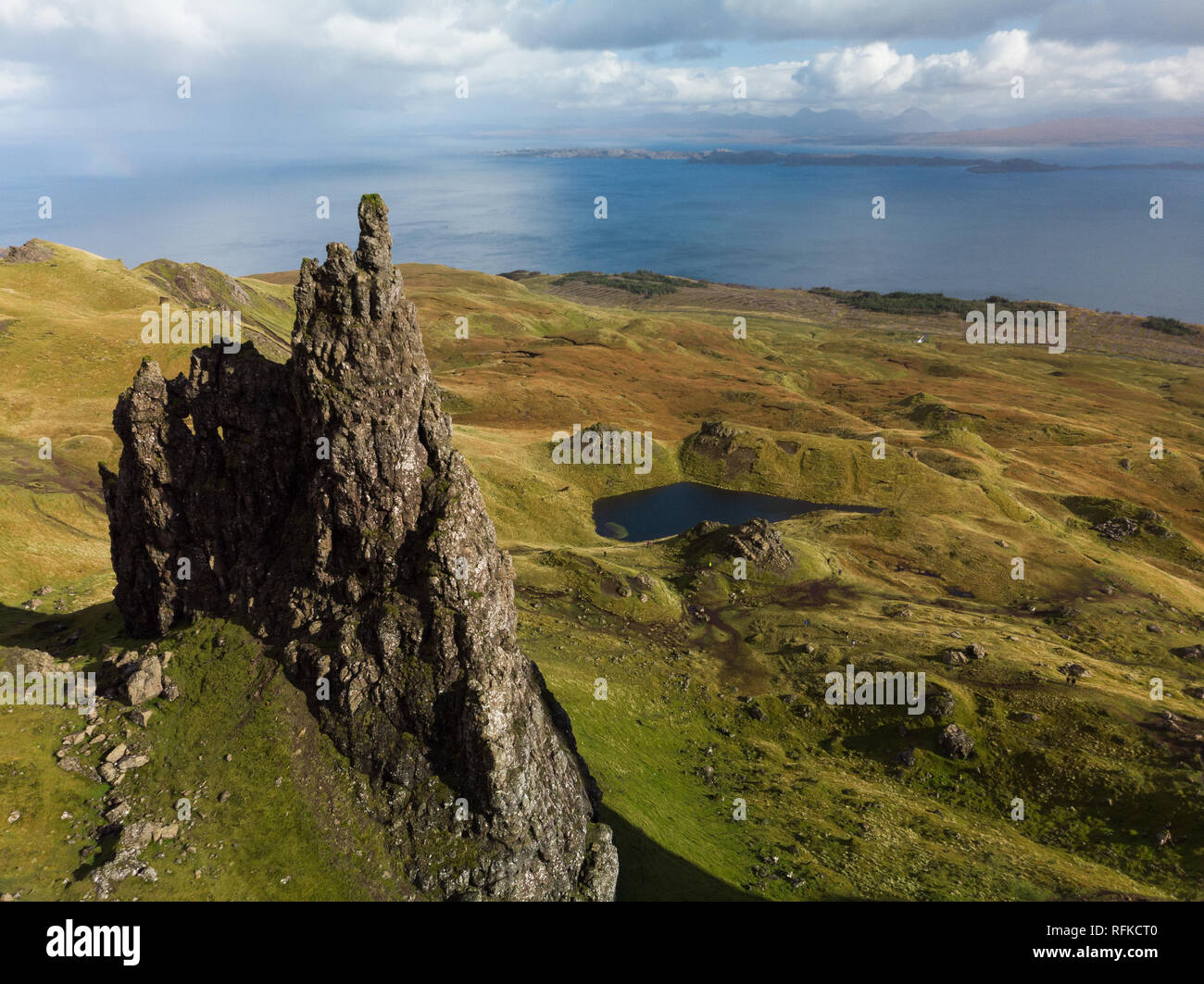 Aerial view of the Old Man of Storr with blue sky and clouds during a clear autumn day (Isle of Skye, Scotland, United Kingdom) Stock Photo