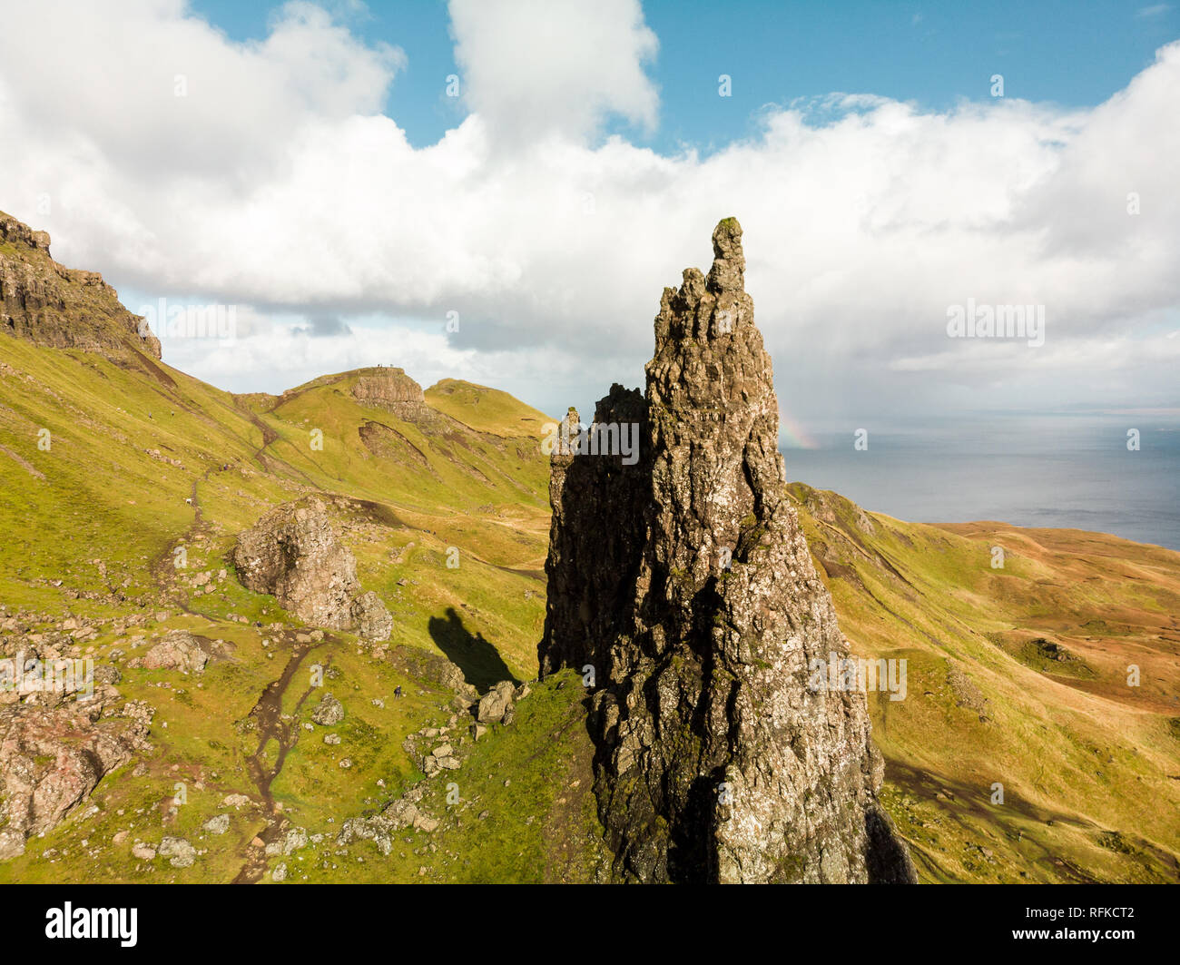 Aerial view of the Old Man of Storr with blue sky and clouds during a clear autumn day (Isle of Skye, Scotland, United Kingdom) Stock Photo