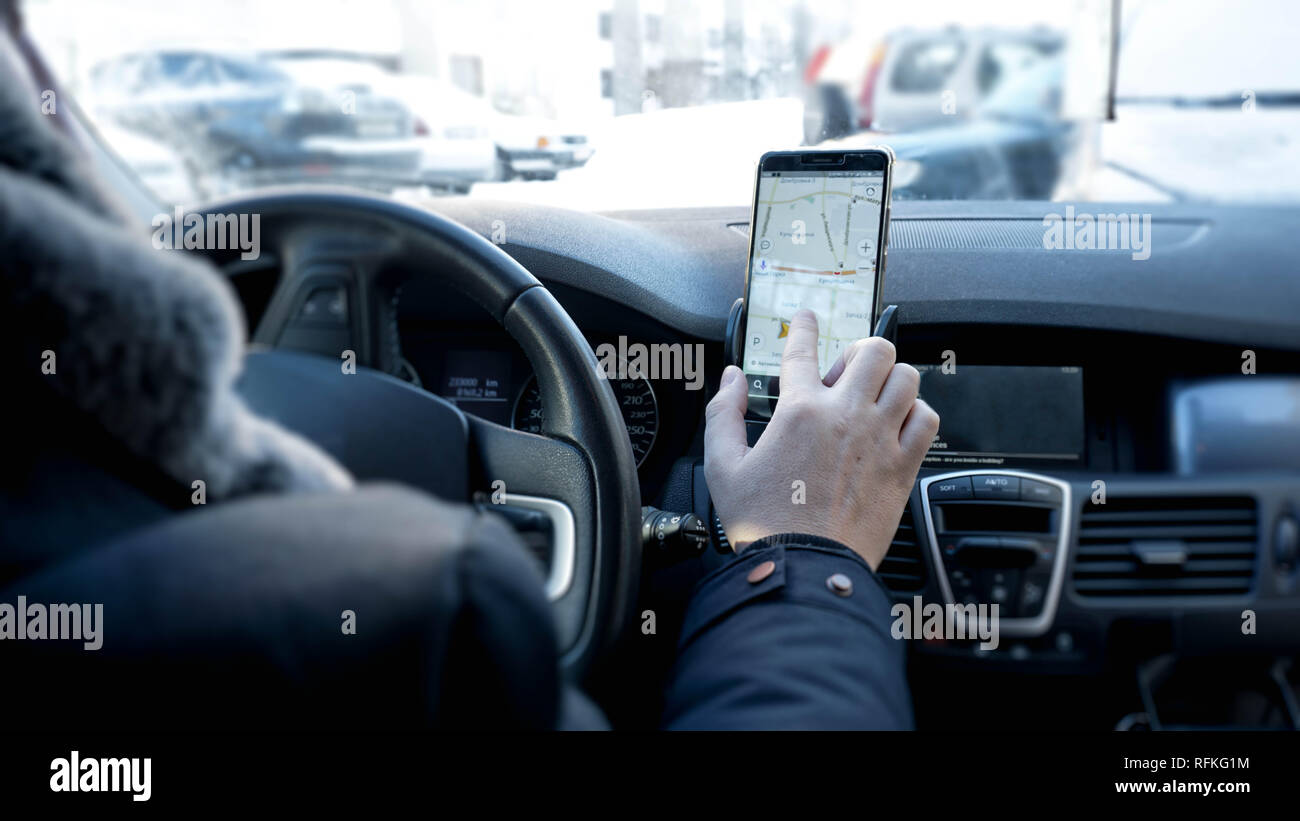 Transport, modern technology and people concept - male hand searching for route Stock Photo