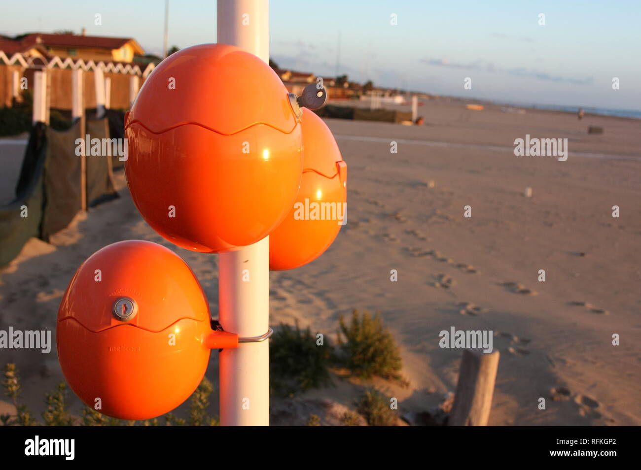 cute orange eggs, oval balls for charging mobile phones right by the sea.  rechargeable battery for smartphone on the beach. brilliant idea Stock  Photo - Alamy