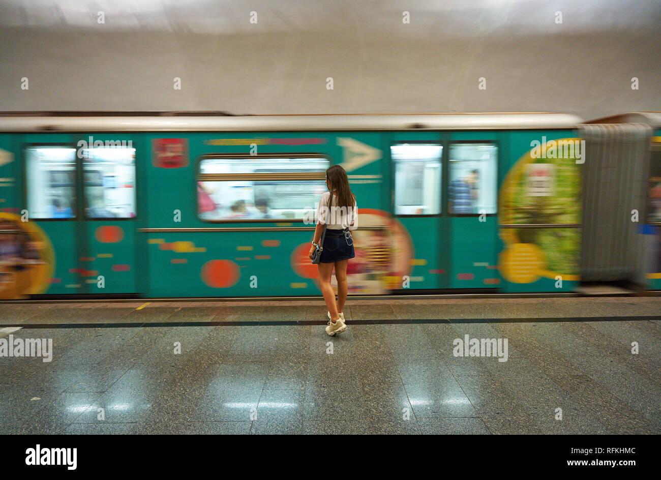 Girl is waiting for metro in a station in Moscow Metro line, Russia