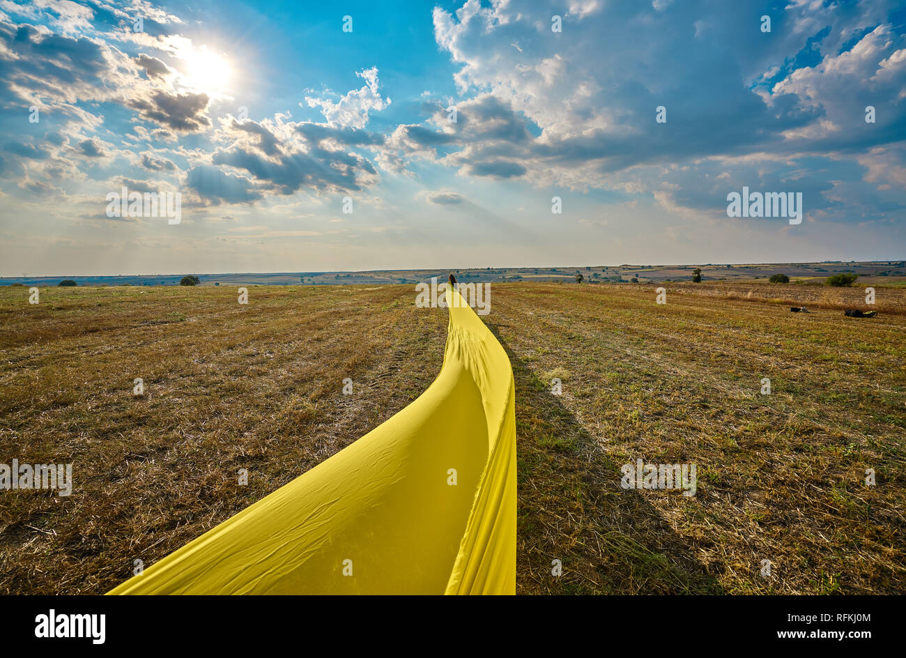 Yellow dressed girl model is posing on the field after harvesting, Kirklareli, Turkey. Stock Photo