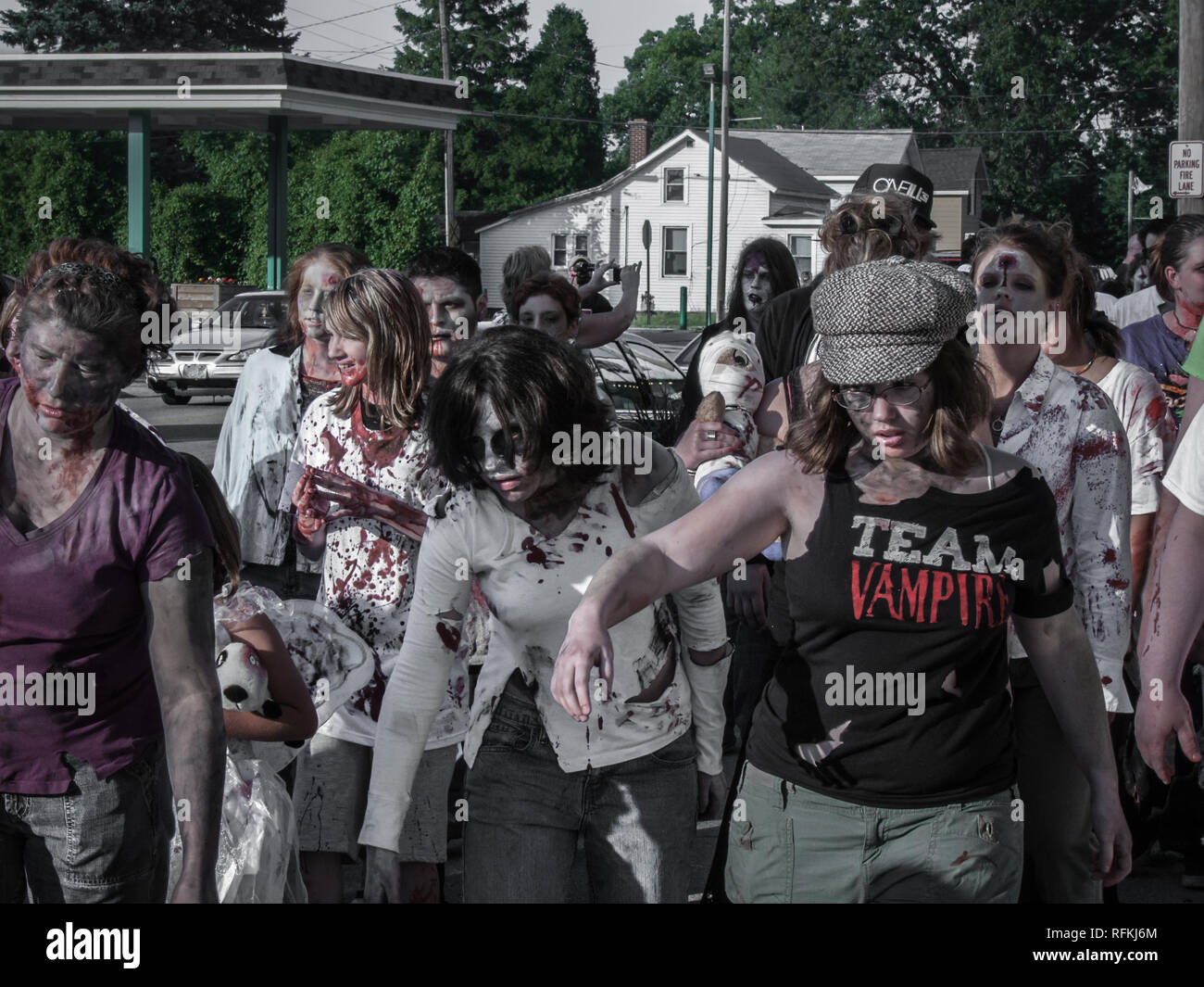 Women dressed as zombies parade on a street during a June 2010 zombie walk flash mob in Michigan Stock Photo