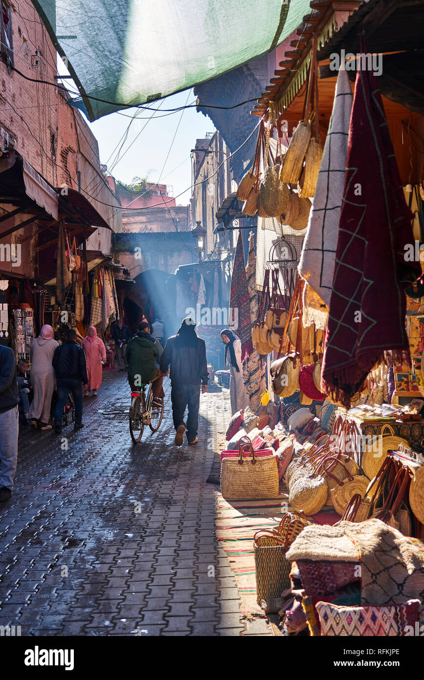 Scene of a traditional souk - bazaar - street of Marrakesh and Moroccan people. Marrakech, Morocco Stock Photo