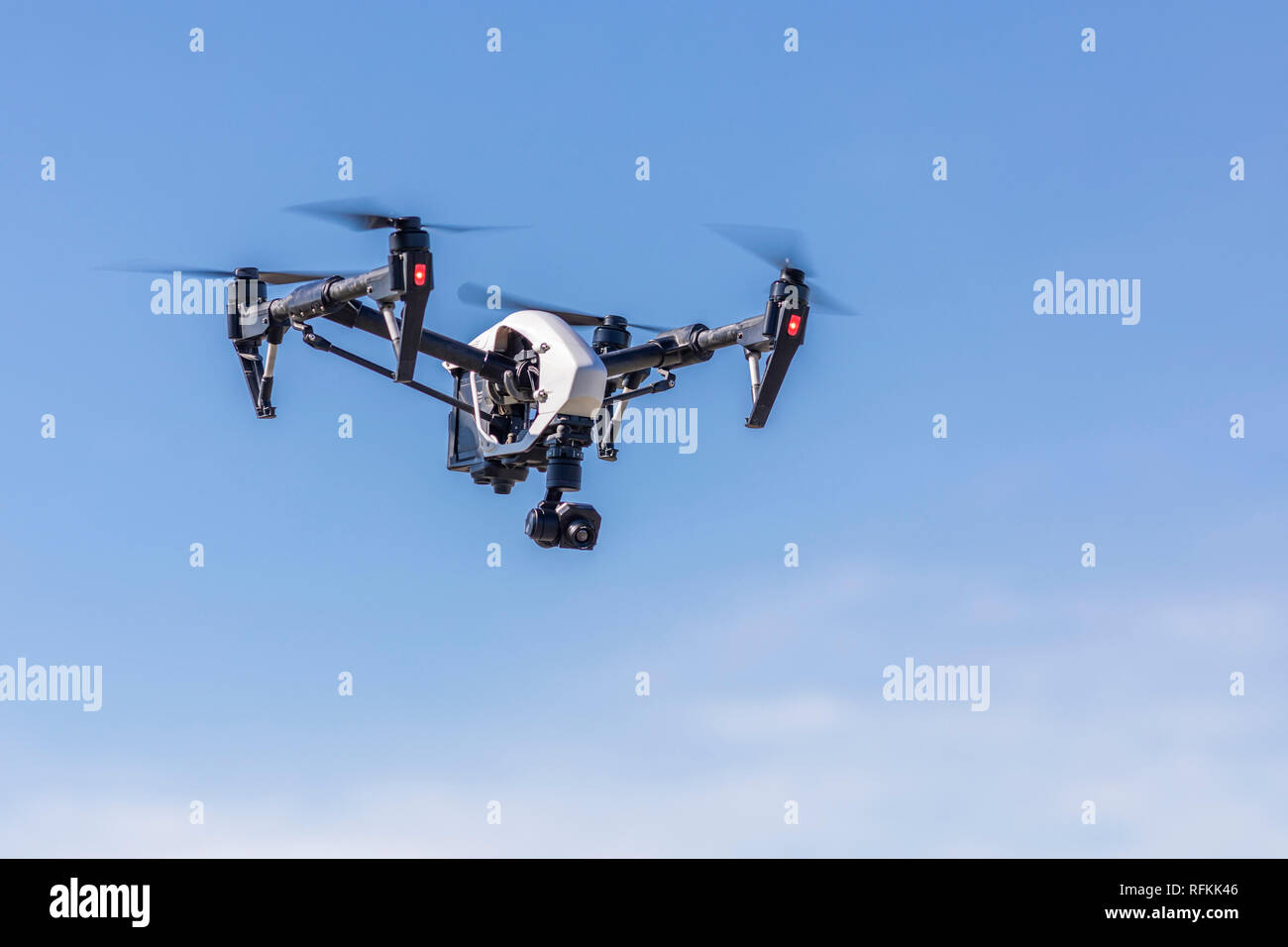 Unmanned Aerial Vehicle (UAV) or drone flying silhouetted above the ...