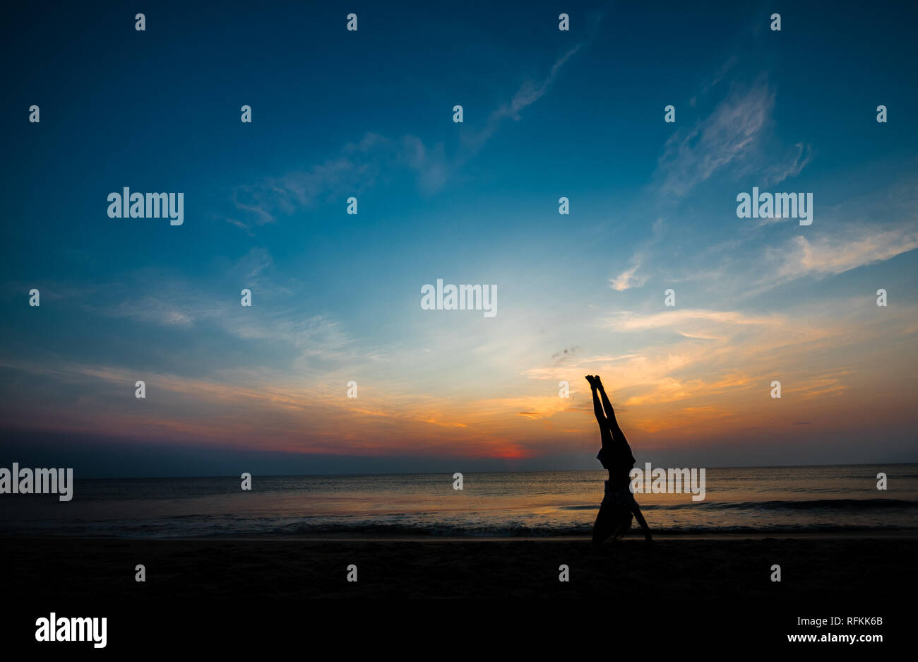 Sunrise Handstand on the Beach Stock Photo