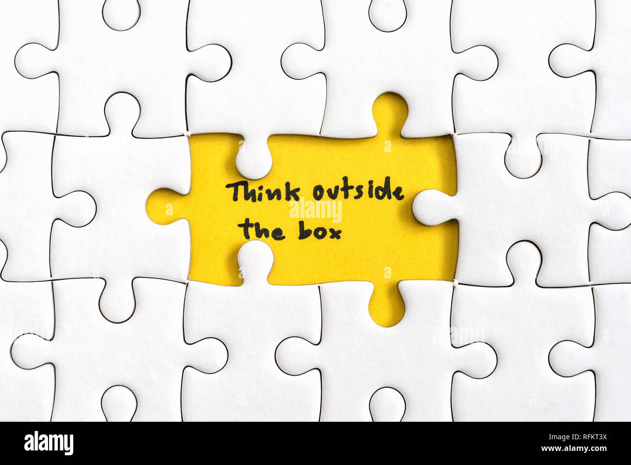 Jigsaw puzzle piece with two missing and hand writing letters word think outside the box, Quotes business concept Stock Photo