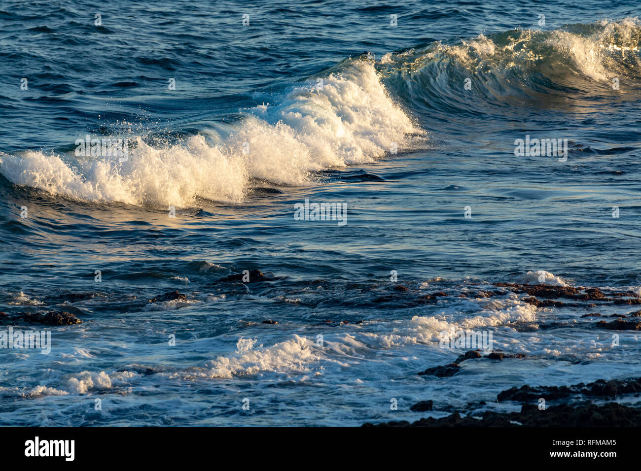Background with dark blue ocean water waves close up on sunset Stock ...