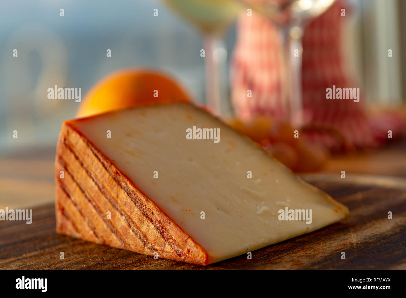 Spanish goat milk cheese with paprika coating and ripe pink table