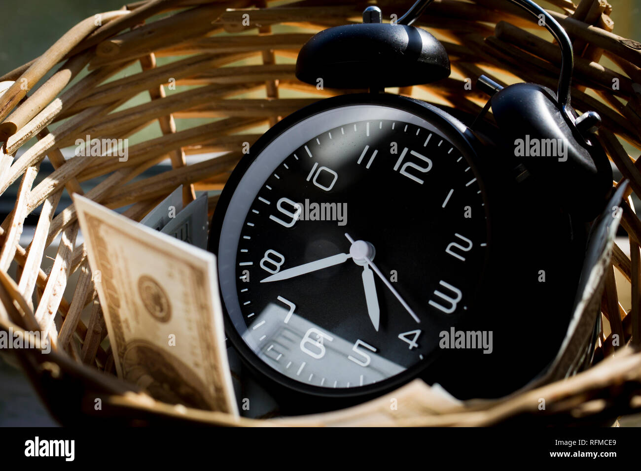 Clock and money, precious time Stock Photo