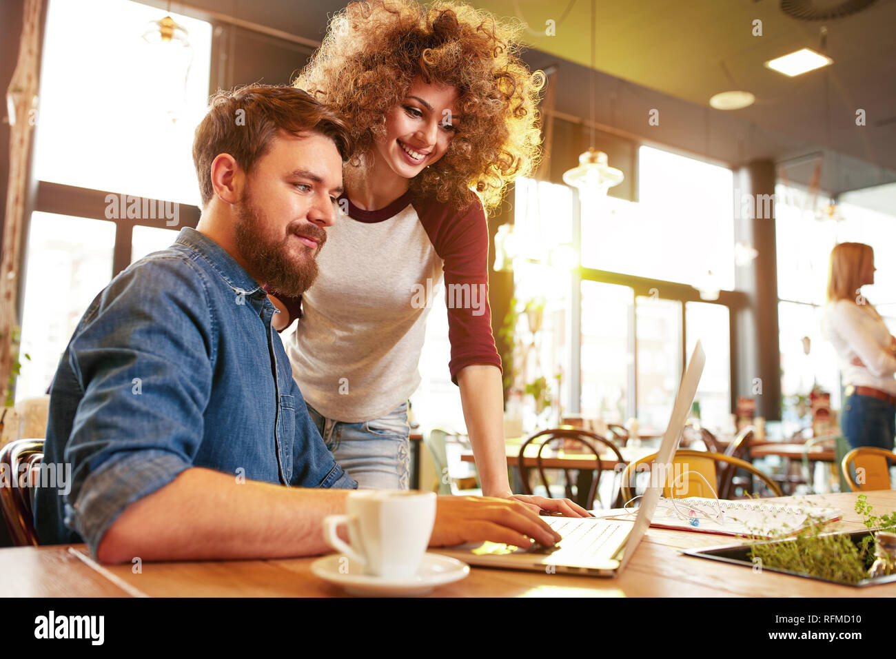 Young male and female looking on laptop indoor Stock Photo