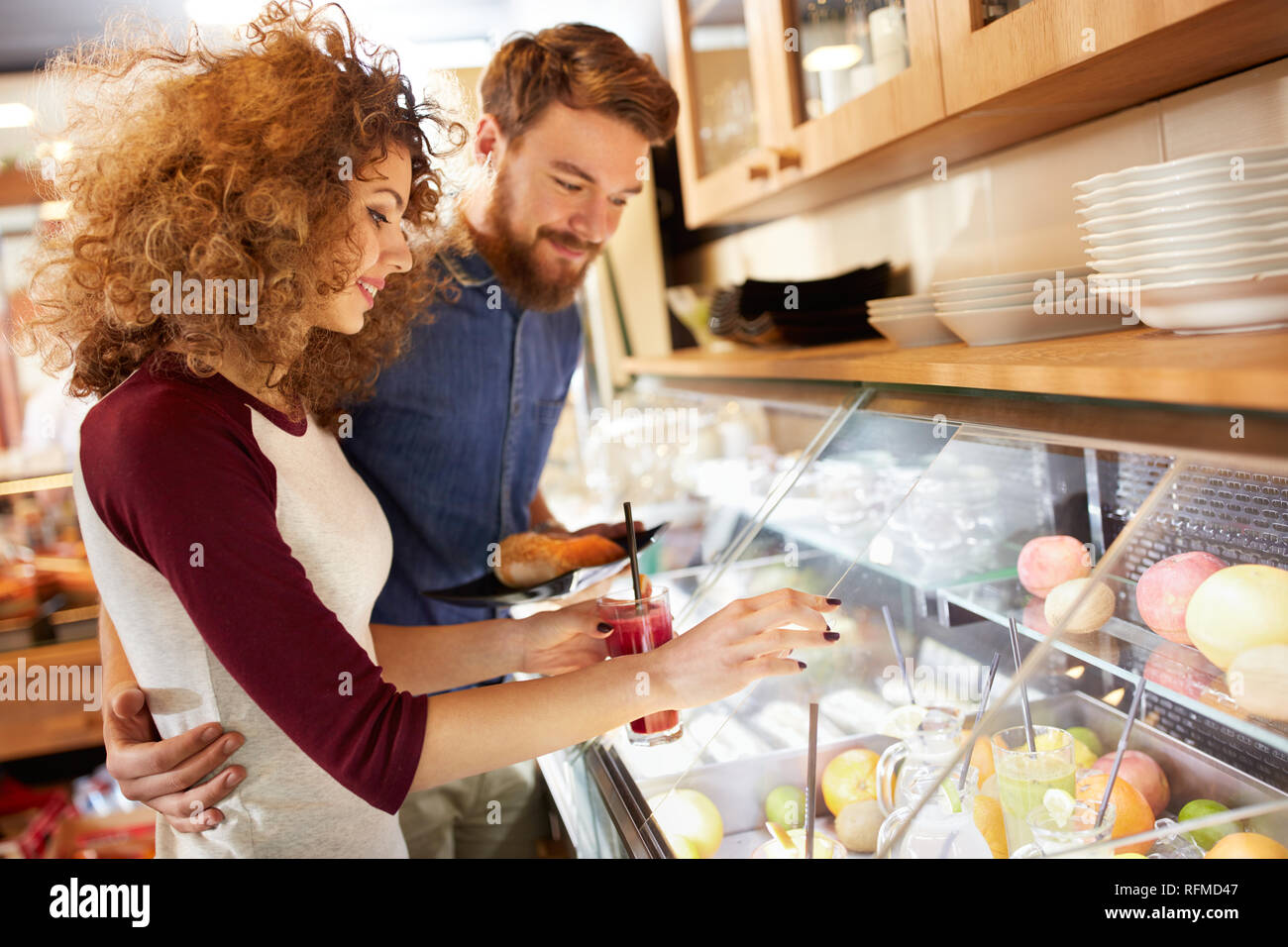 Couple in love chooses in restaurant fresh fruit juice Stock Photo
