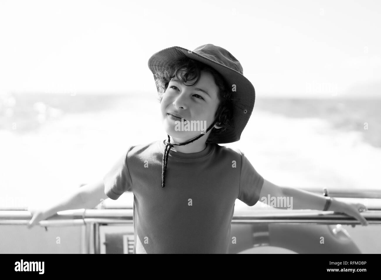 Portrait of a boy on the deck of a pleasure ship. Black and white. Stock Photo