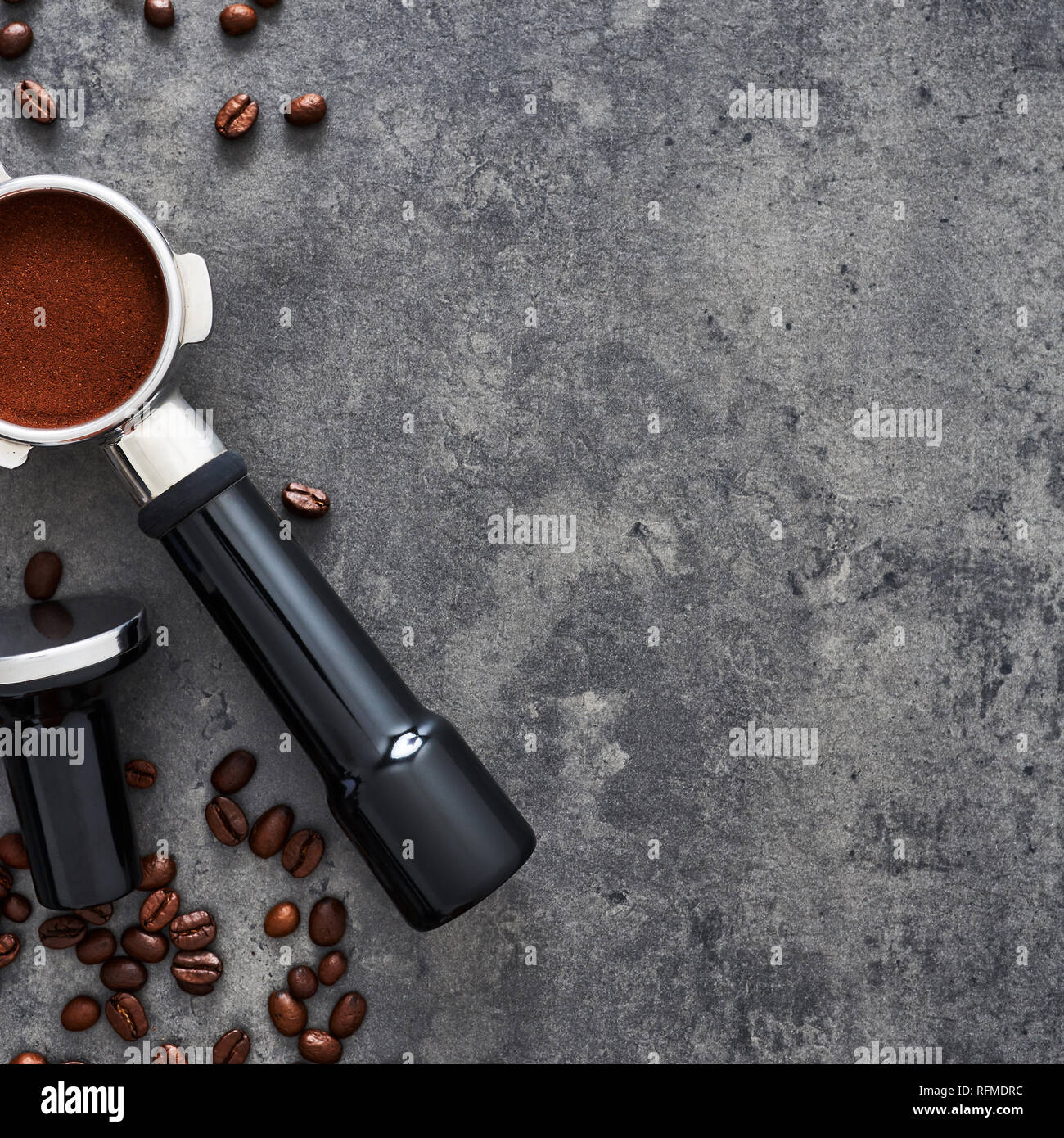 Top view of coffee background. Assorted coffee beans, ground coffee, portafilter and tamper on dark concrete background. Flat lay. Copy space for text Stock Photo