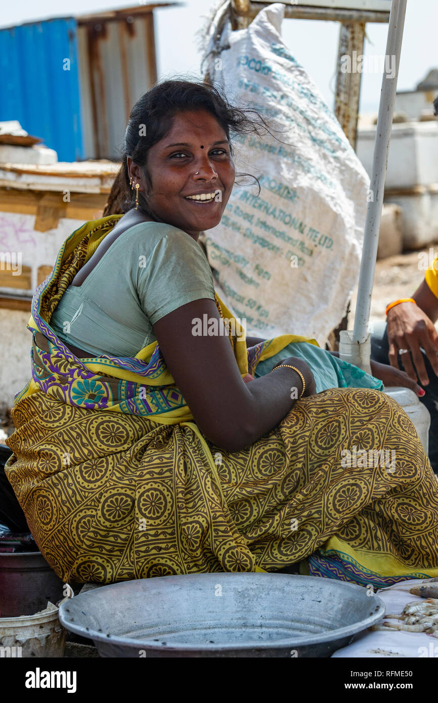 A happy, pretty girl working at a fish market on Marina beach, Chennai in Southern Indi Stock Photo