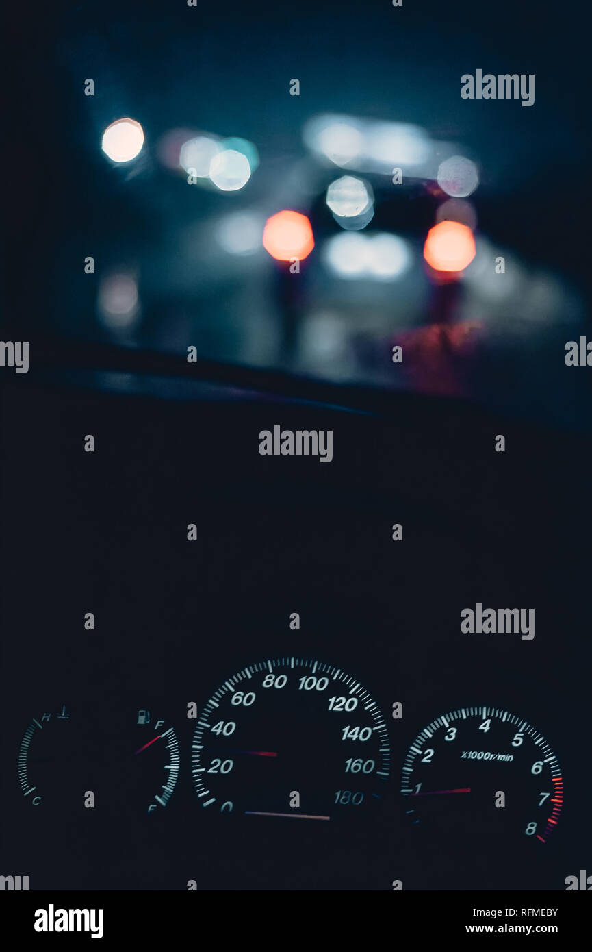 night traffic jam in bed rainy weather. copy space and bokeh. speedometer. Stock Photo