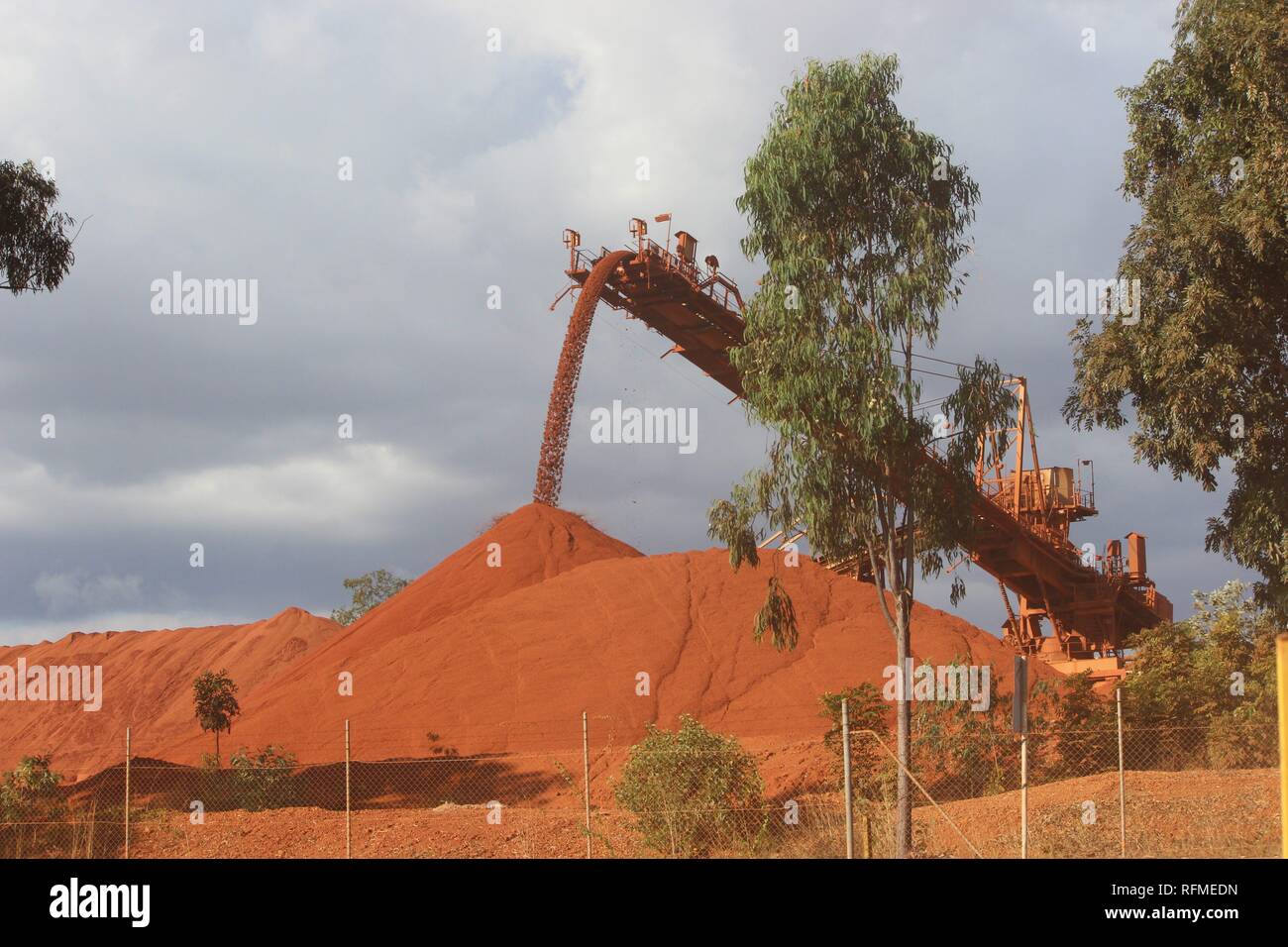 Red Bauxite pile coming off conveyor at Bauxite mine in Weipa North