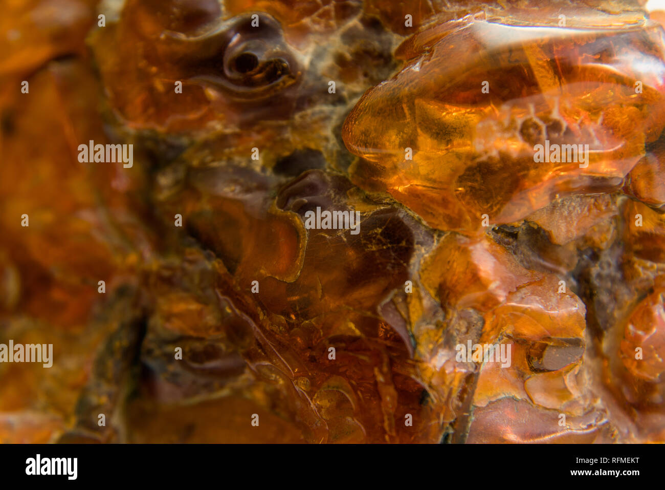 Macro Close up of an amber stones from Baltic sea. Multicoloured background for advertising and banners. Vintage fossilised resin as a background. Stock Photo