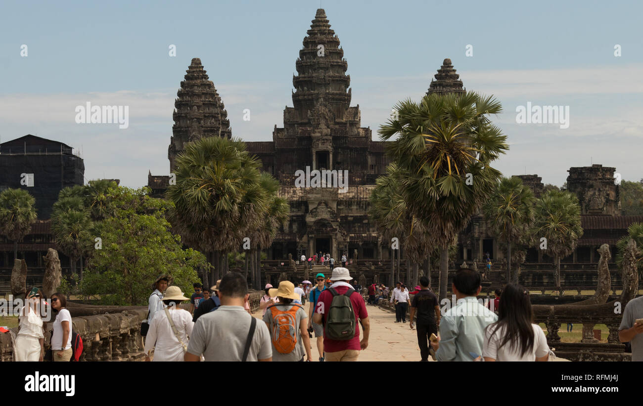 Angkor Wat Temple in Siem Reap, Cambodia; taken from the walkway between the outer walls and the main temple during a busy tourist day. Stock Photo