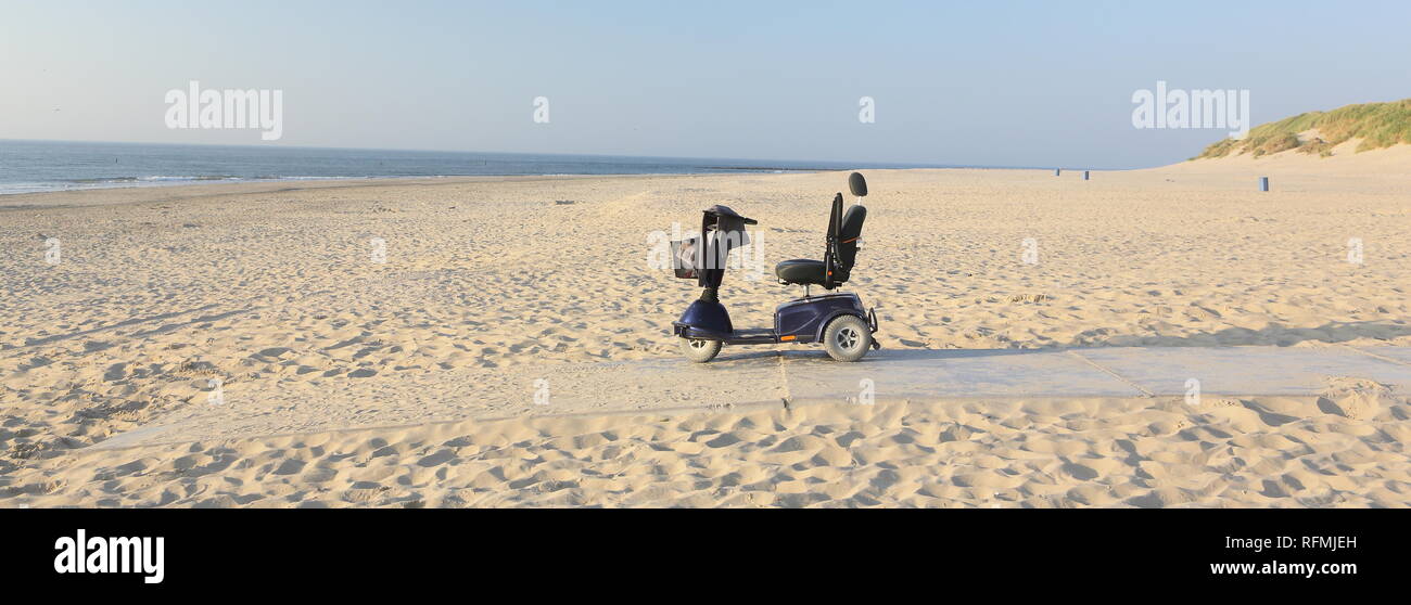 Handicap chair on North sea beach Stock Photo Alamy