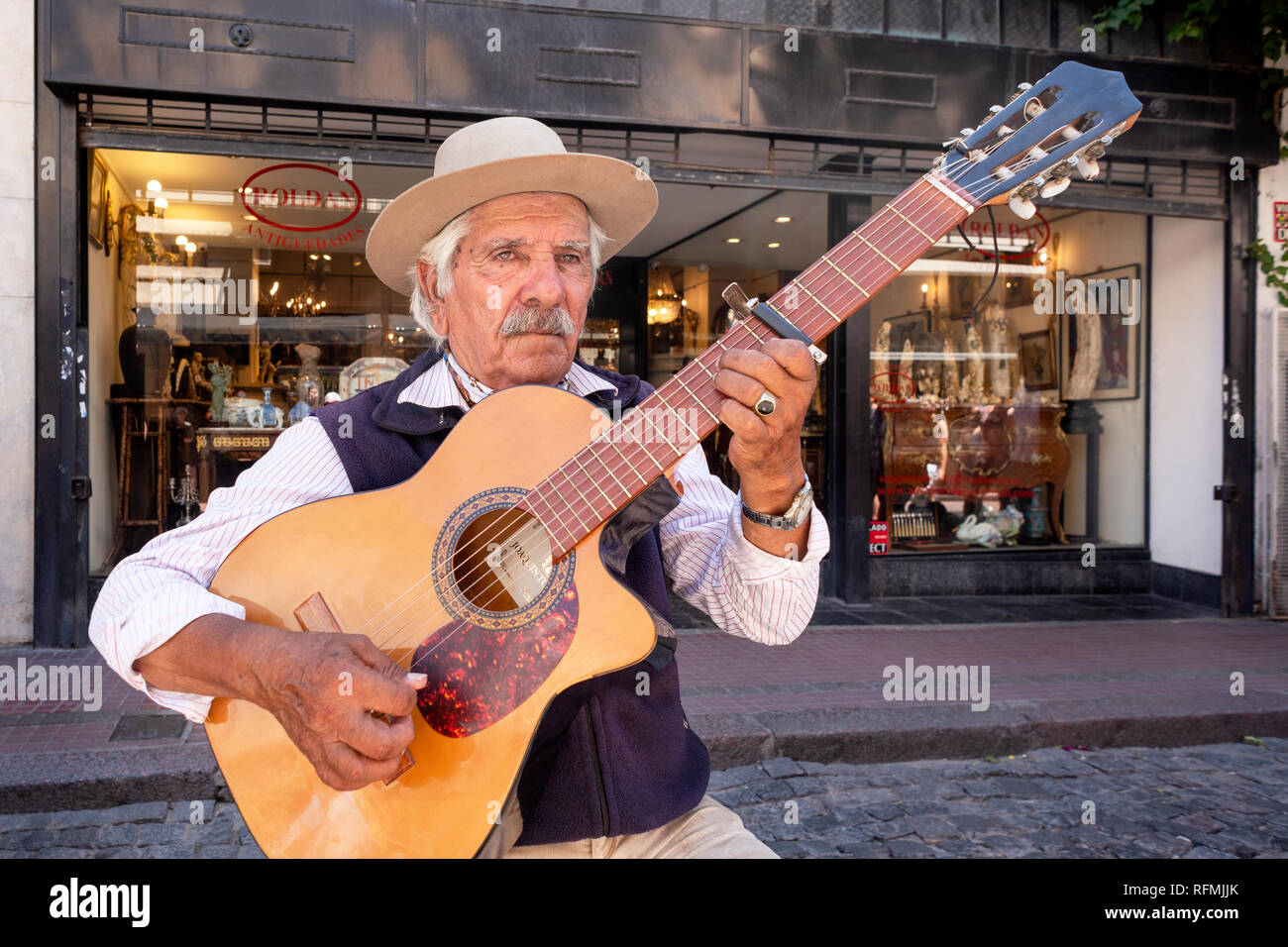 Street performer, playing Spanish guitar, during the SanTelmo market, Buenos Aires, Argentina. Stock Photo