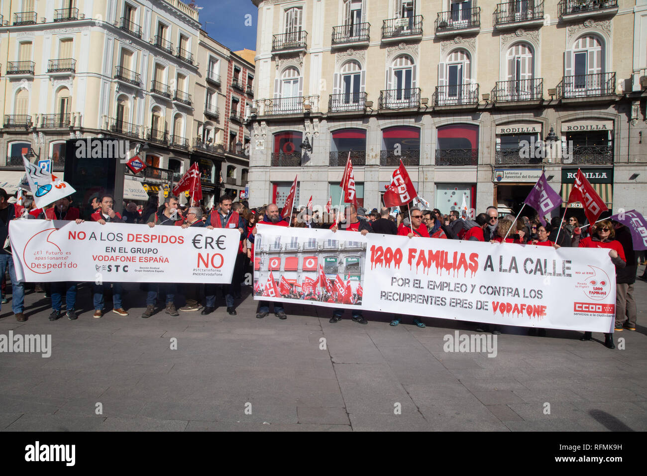 Protesters are seen holding banners and flags during the protest. Hundreds of Vodafone workers protest at the Puerta del Sol to demand the company not to lay off more than 1200 employees in Directorate General for Employment. Stock Photo