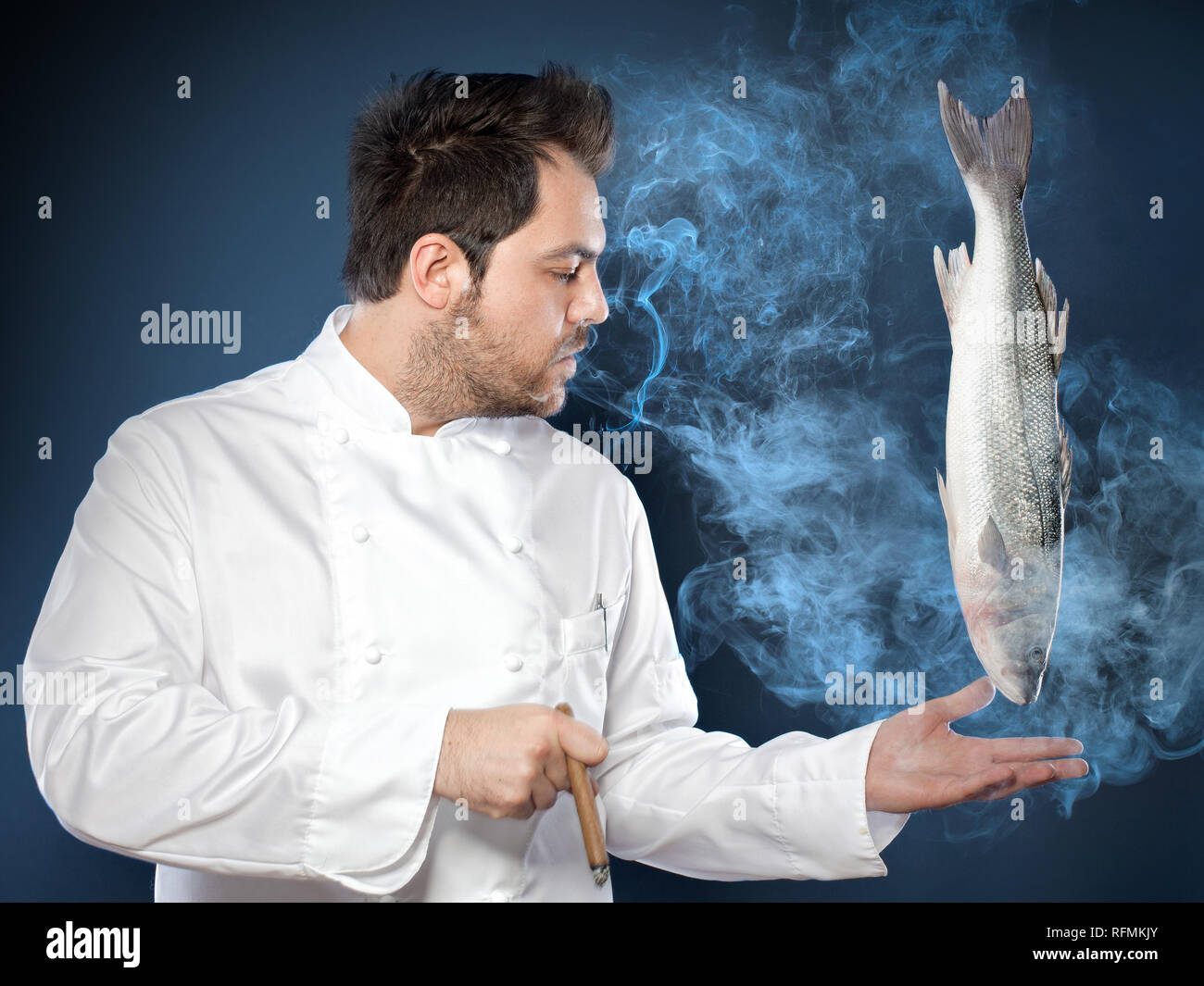 Young handsome chef with sea bass fish smoking cigar Stock Photo Alamy