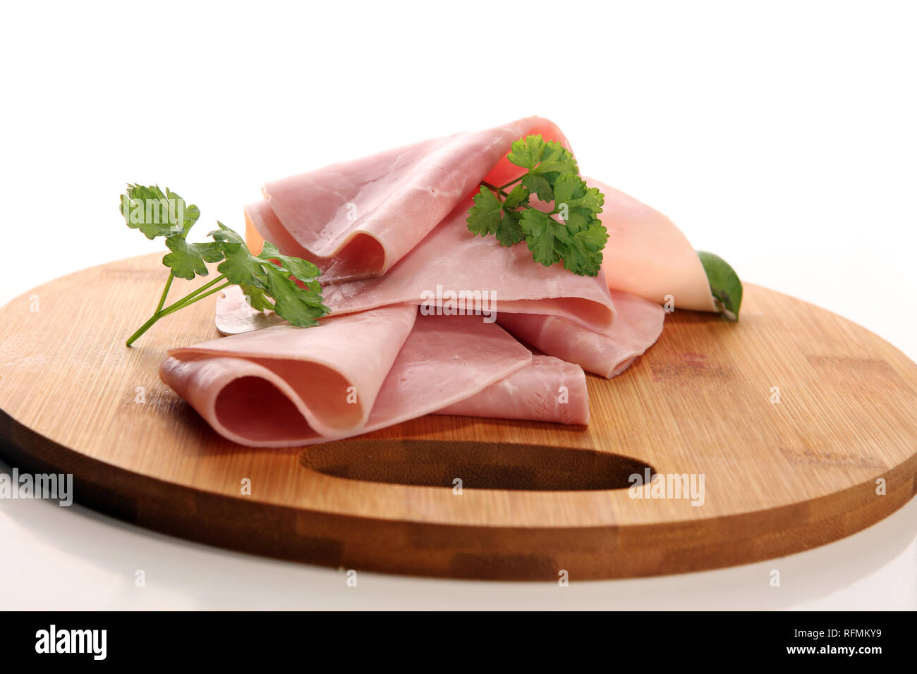 Snacking Ham Sliced ham with parsley on table. Fresh prosciutto. Pork ham sliced ...