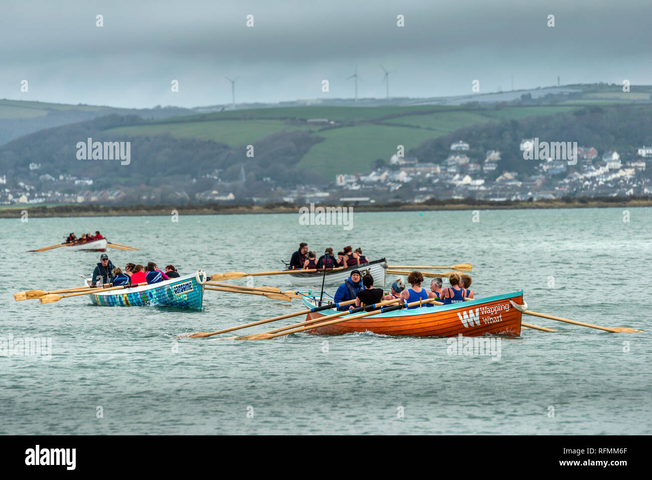 UK Weather - Saturday 26th January. On a cold overcast day in North Devon, Pilot Gig Boats gather at the quayside in the village of Appledore to do ba Stock Photo