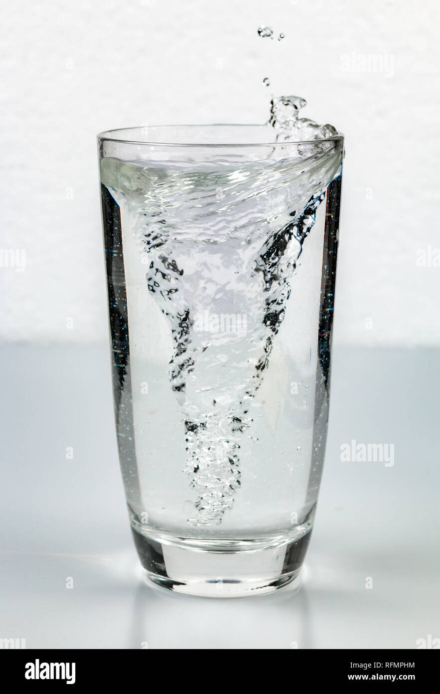 vortex whirlpool in glass of water Stock Photo
