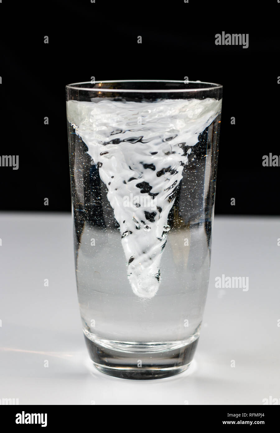 vortex whirlpool in glass of water Stock Photo