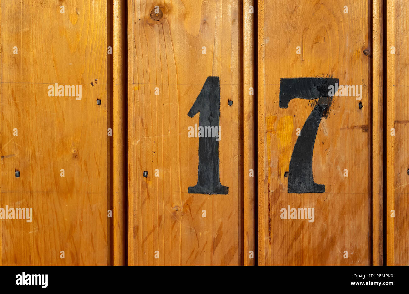 number 17 on door of storage room for tenants in century-old apartment building in stockholm Stock Photo