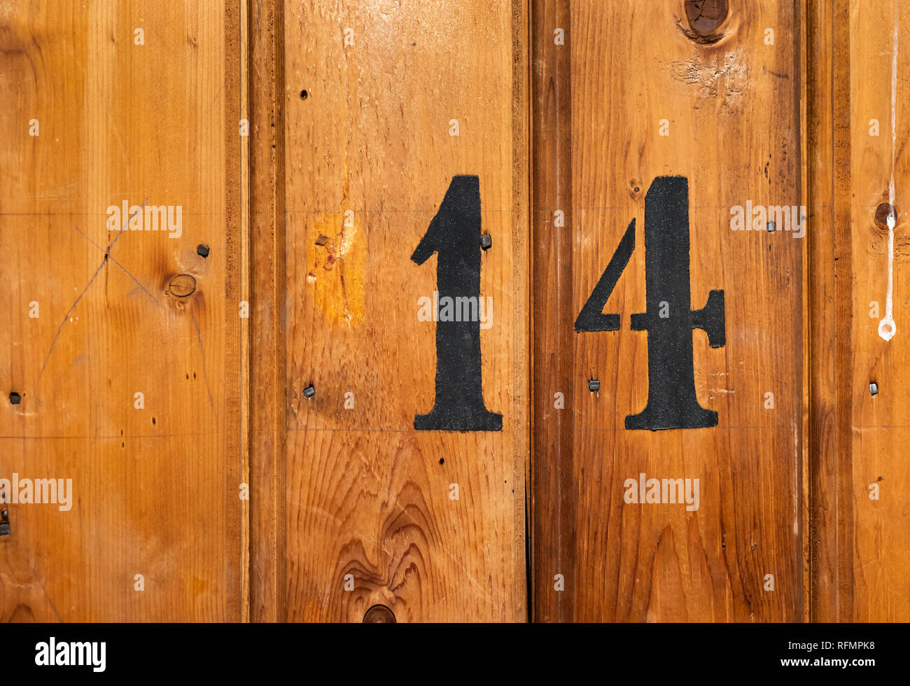 number 14 on door of storage room for tenants in century-old apartment building in stockholm Stock Photo