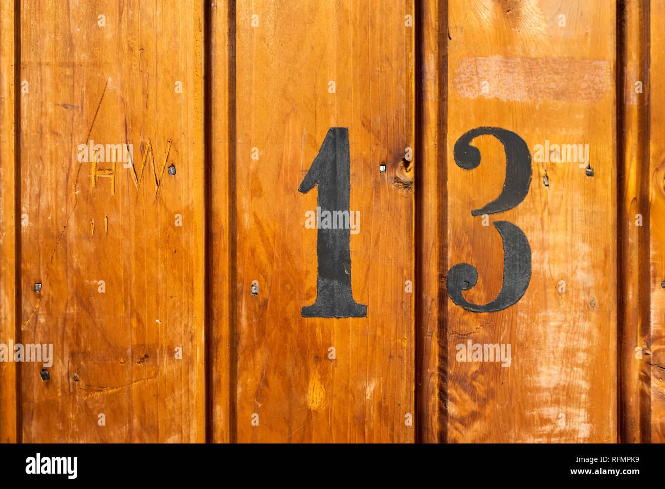 number 13 on door of storage room for tenants in century-old apartment building in stockholm Stock Photo
