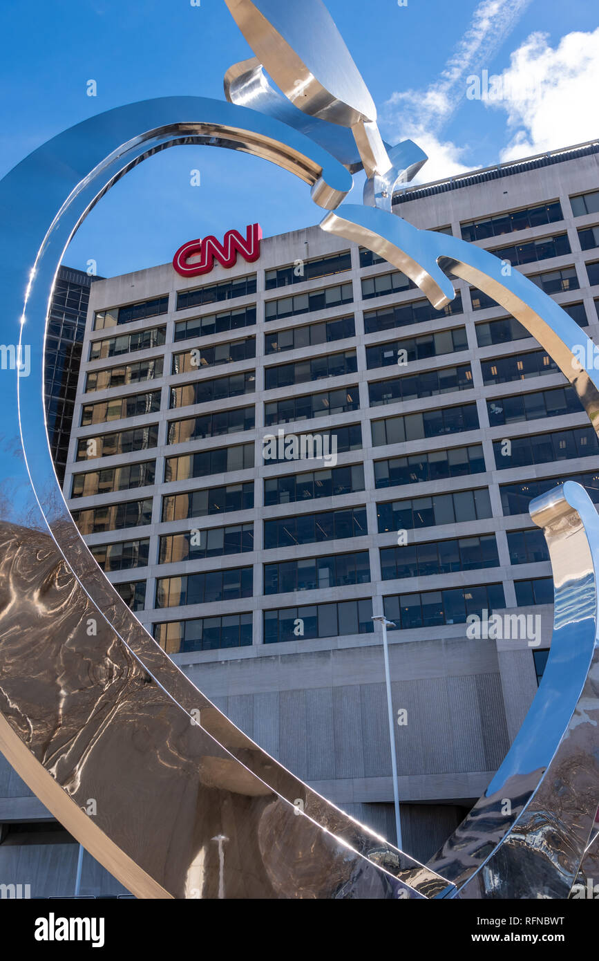 CNN Center, world headquarters of the Cable News Network, seen through a large chromed Georgia peach sculpture in downtown Atlanta, Georgia. (USA) Stock Photo