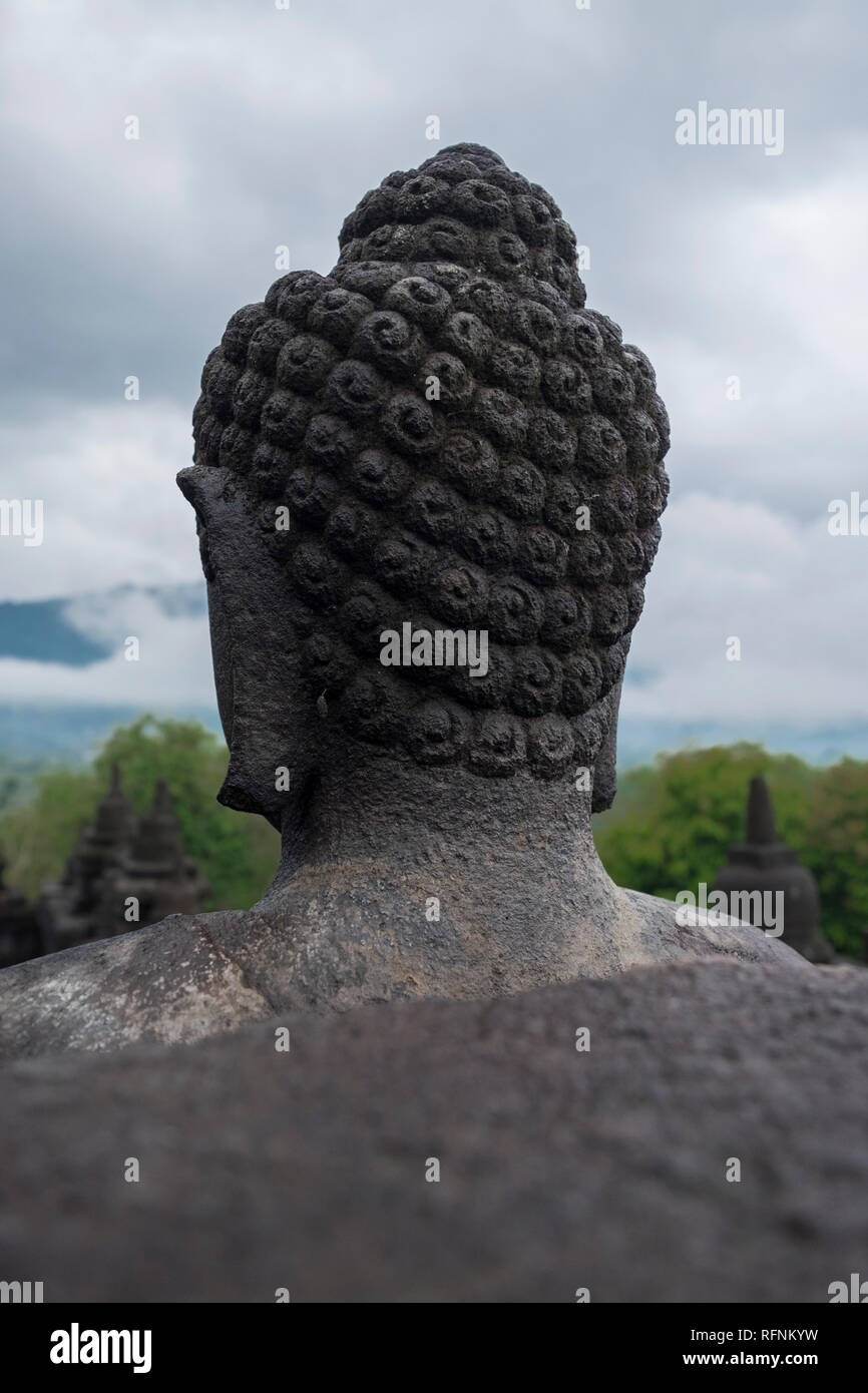 Looking from behind a Buddha head at Borobudur temple in Java, Indonesia. Stock Photo