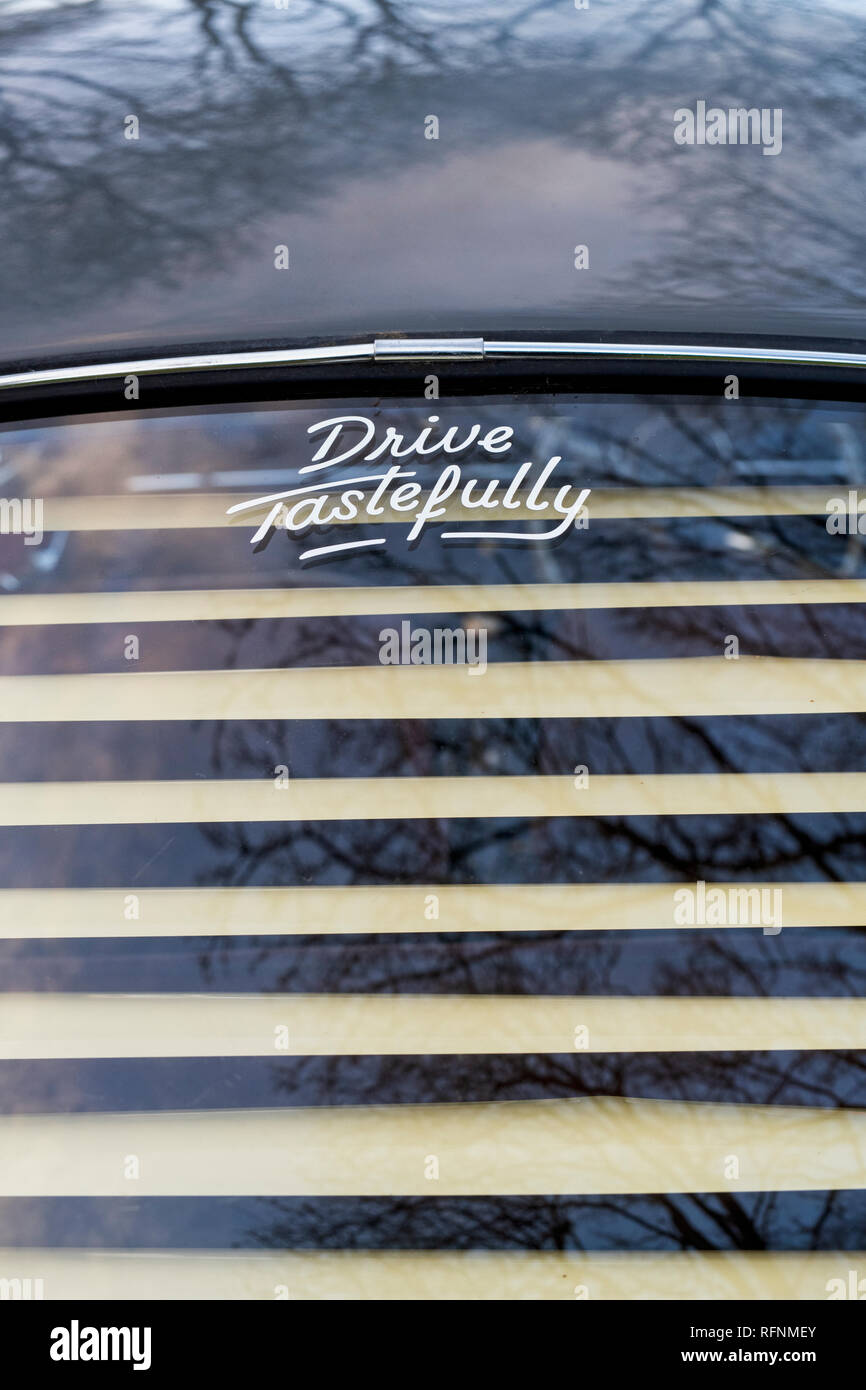 Drive tastefully sticker in the rear window of a vintage VW Beetle car at Bicester heritage centre. Bicester, Oxfordshire, UK Stock Photo
