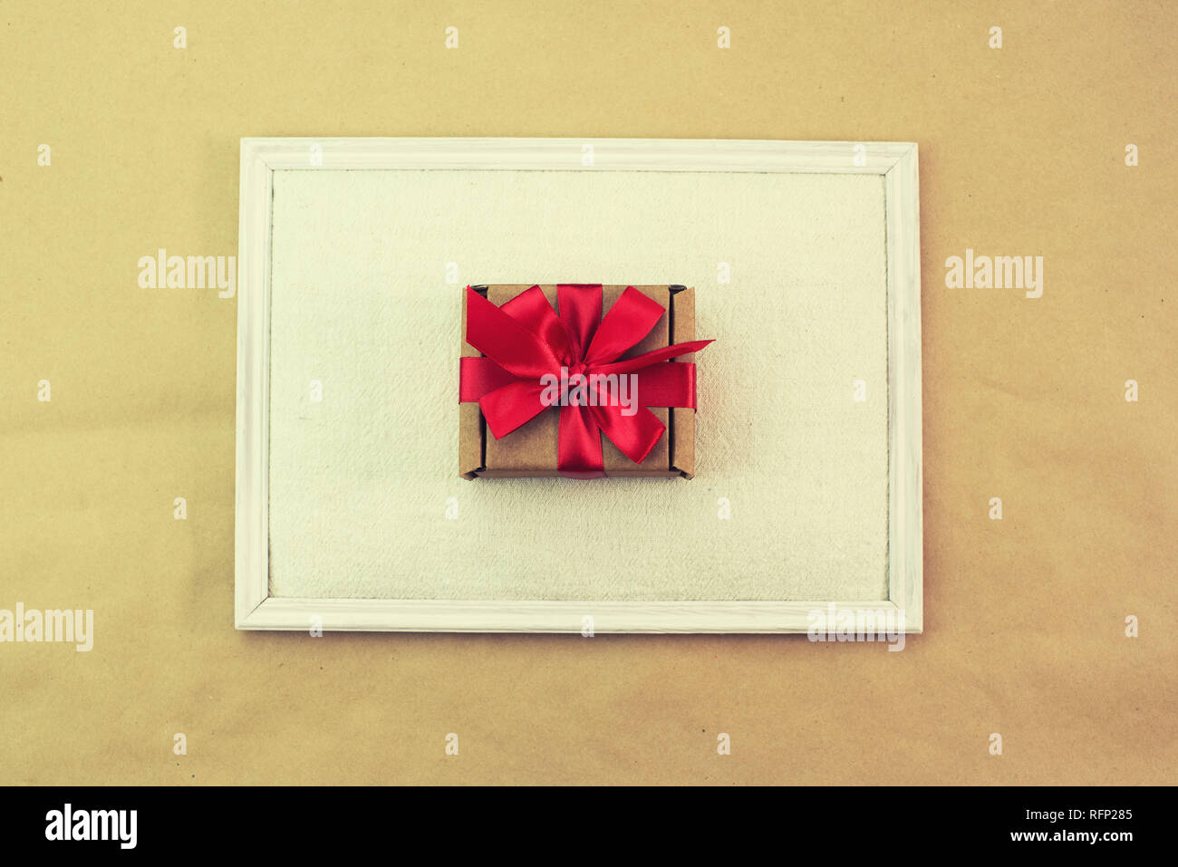 Gift in Kraft box red bow congratulations. Top view copy space Stock Photo
