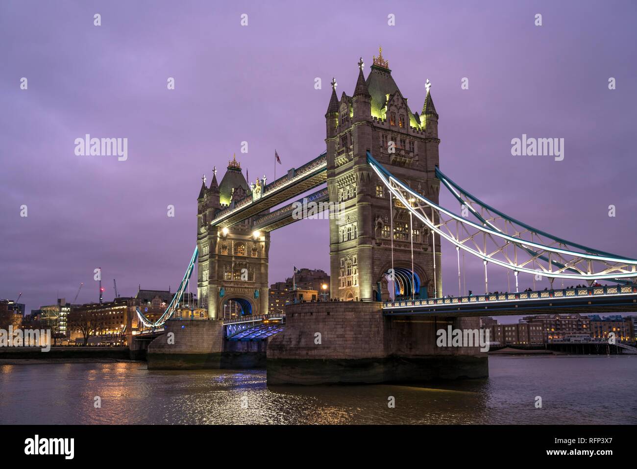 Illuminated Tower Bridge at dusk, London, Great Britain Stock Photo