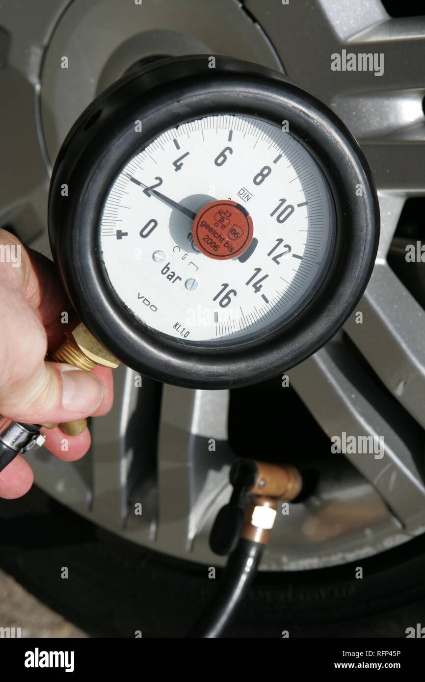 Measuring the pressure of a tyre hires stock photography and images