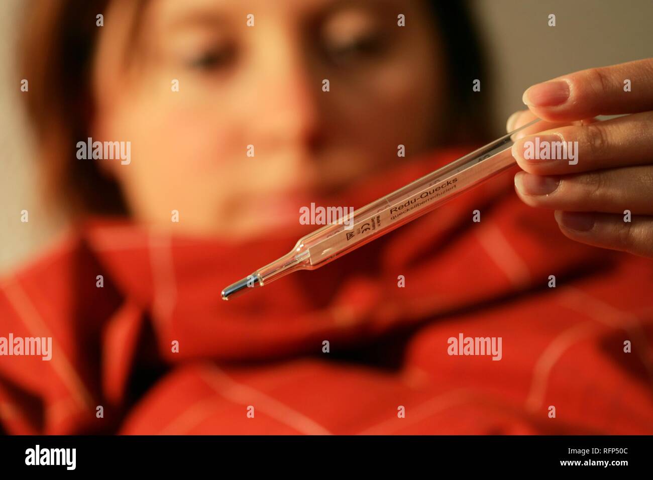 https://c8.alamy.com/comp/RFP50C/woman-measures-her-blood-heat-with-a-clinical-thermometer-common-cold-RFP50C.jpg