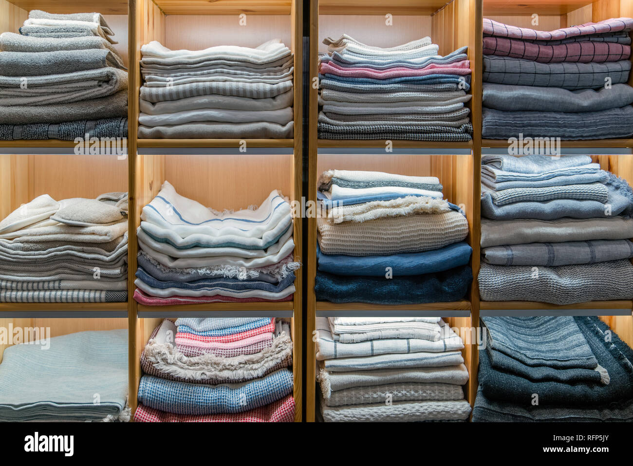 Modern Wooden Wardrobe With Different Types Of Clothing Folded And