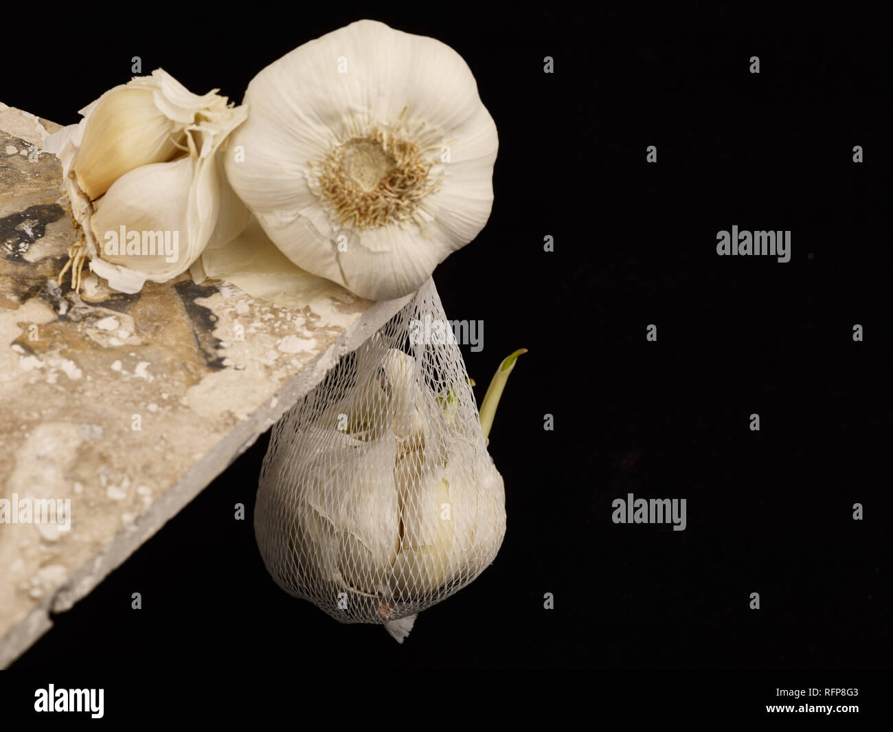 Garlic clove against a black background, vegetable food photograph Stock Photo