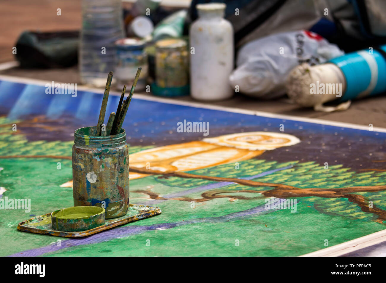Tools of a street painter in a public street. Stock Photo