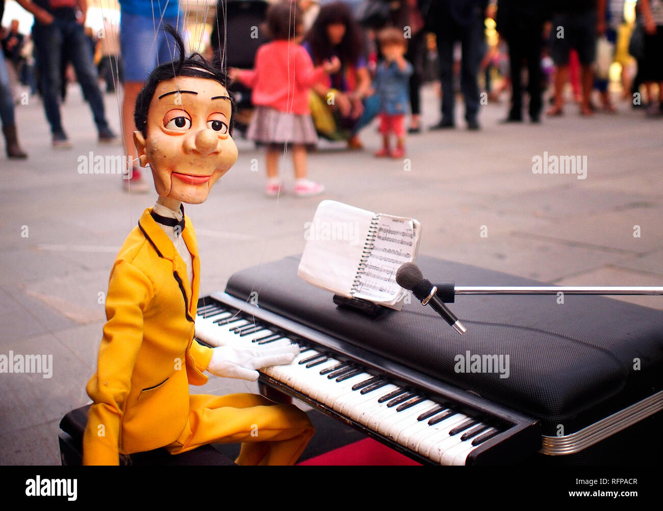 Male marionette, a pianist, in a street show Stock Photo