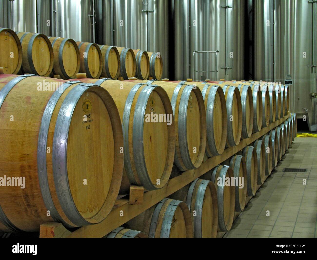 Wine cellar with wooden barrels and stainless steel containers Stock Photo