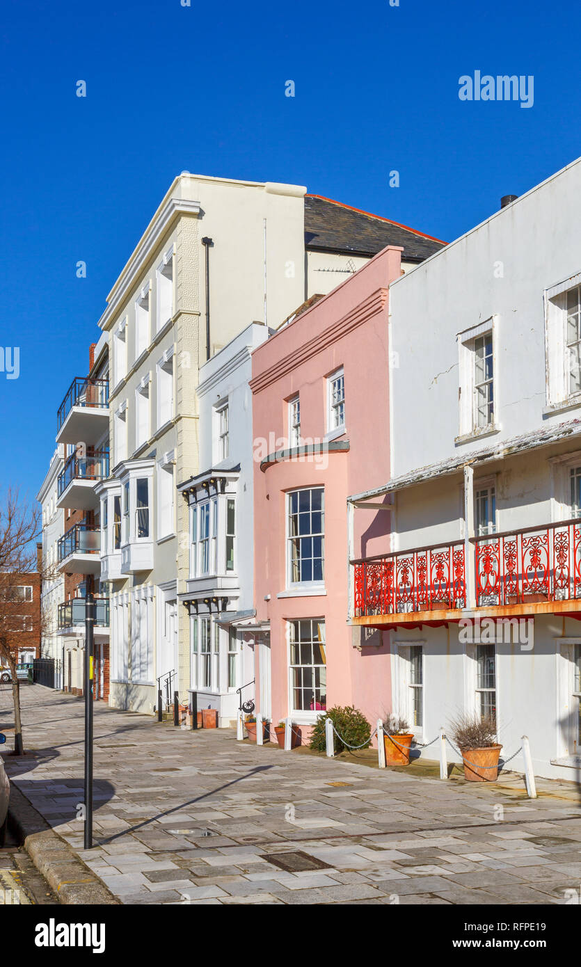 Georgian houses in Grand Parade, Old Portsmouth, Hampshire, UK including terraced houses with pink bow-fronted window and red wrought iron balcony Stock Photo