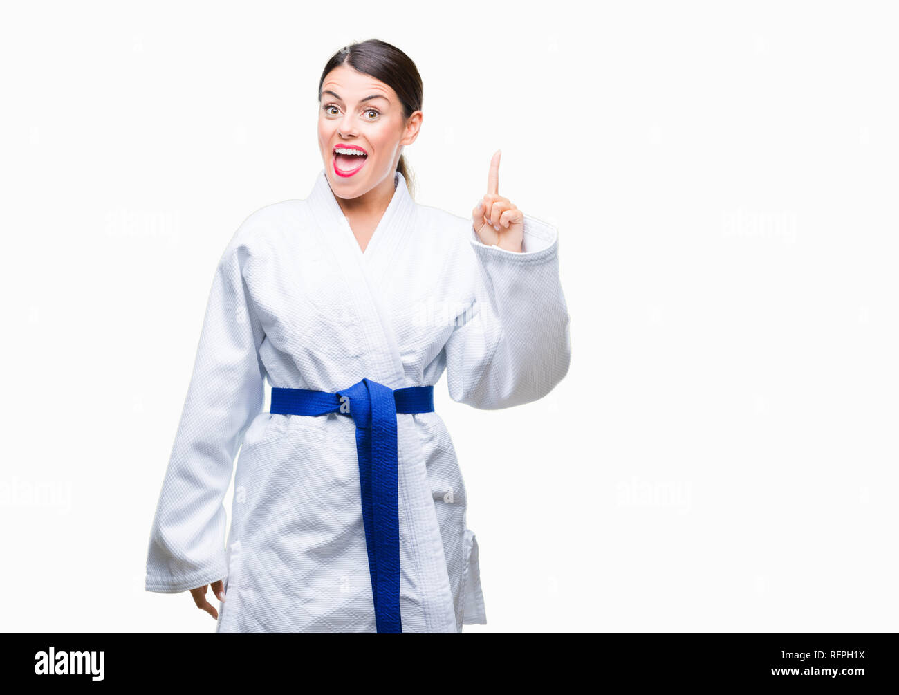 Young beautiful woman wearing karate kimono uniform over isolated
